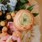 Romantic B&Bs - From above of fragrant bouquet with fresh peach buttercups composed with roses and green leaves in daylight