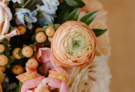 Romantic B&Bs - From above of fragrant bouquet with fresh peach buttercups composed with roses and green leaves in daylight