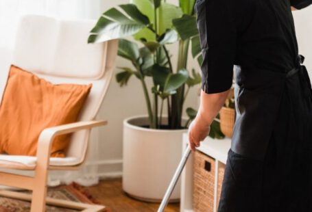 Housekeeping Services - A Woman Sweeping a Floor