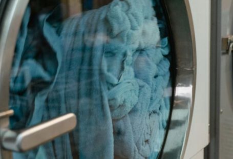 Laundry Services - Blue Towels in a Front Load Washing Machine