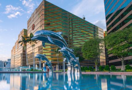 Luxury Hotels - Three Blue Dolphins Statue Front of Water Near Building