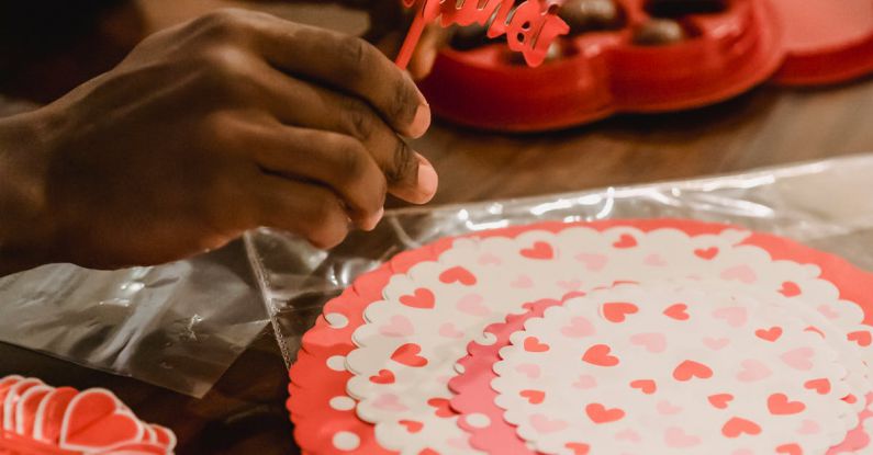 Romantic Spots - Black man making decorations for Saint Valentine Day