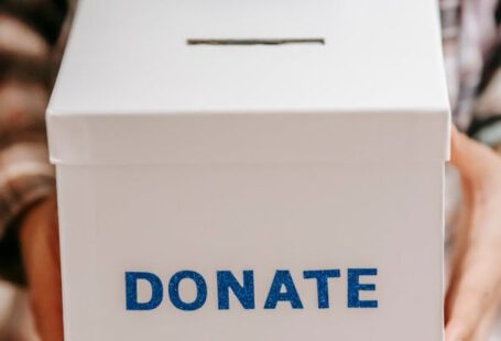 Benefits - Crop anonymous person showing donation box